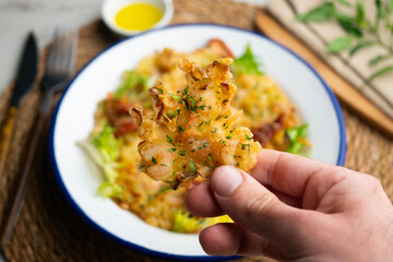 A Spanish tapa of Tortillas de camarones. Small portions of fried fritters with shrimp and vegetables. © Leckerstudio