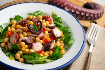 Octopus, chickpea, and vegetable salad. Traditional Spanish octopus salpicon tapa recipe.