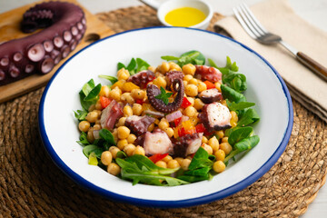 Octopus, chickpea, and vegetable salad. Traditional Spanish octopus salpicon tapa recipe.