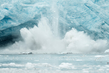 Glacier Calving with Ice Breaking Into Ocean and Water Splashing