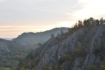 Scenic mountain landscape at sunrise with rocky cliffs