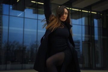 Successful redhead woman in front of the office building