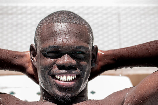 African Man Smiling with Water Droplets