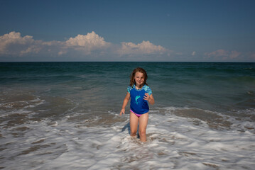 Smiling young girl playing in waves Outer Banks