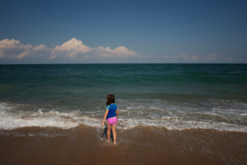Behind young girl walking through waves Cape Hatteras National S