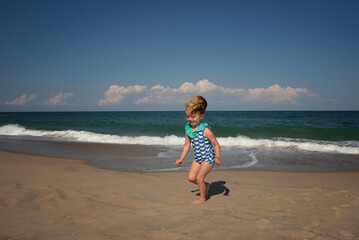 Happy toddler playing in sand on beach Outer Banks