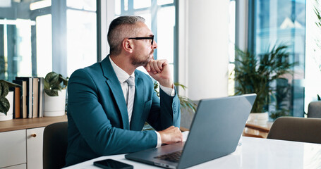Naklejka premium Laptop, thinking and vision with business man in office of corporate company for management. Computer, future and planning with mature employee in workplace for decision, solution or strategy