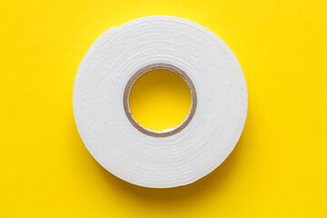 Strong, double-stick foam tape. Double-sided tape on a yellow background.