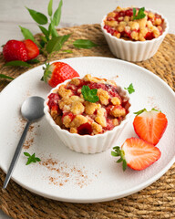 Homemade strawberry crumble in an individual mold, baked in the oven.