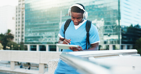 Medical student, city and black man on tablet with headphones for education, audiobook and podcast....