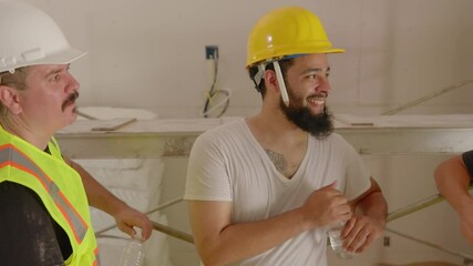 A joyful builders beams with happiness while collaborating with a diverse team at a busy construction site, highlighting the importance of teamwork and creativity in house renovation