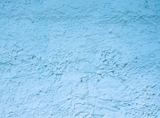 A blue wall with a rough texture