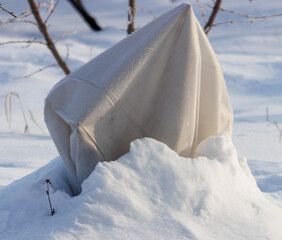 A white object is buried in the snow