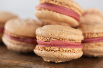 Vegan homemade macaroons with raspberry cream, closeup. Healthy dessert. Sugar, lactose and gluten free.
