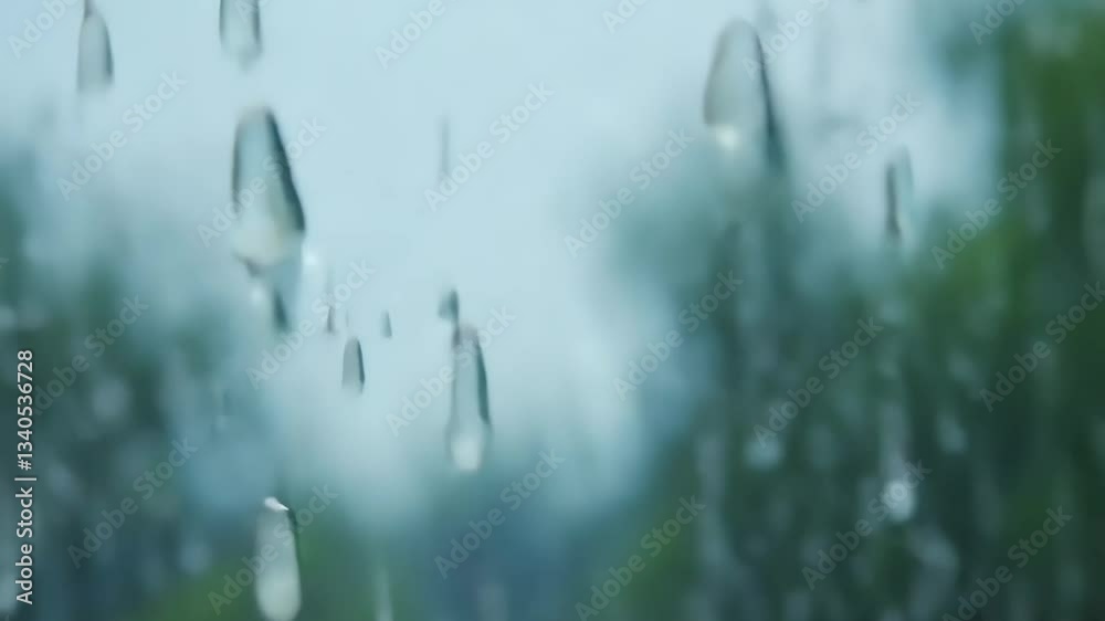 Poster Raindrops on a window. The raindrops are small and scattered. The window is clear and the raindrops are visible
