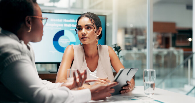 Meeting, discussion and women with tablet, business and serious for mental health assistance programs. Teamwork, HR and planning for workplace wellness, communication and collaboration in boardroom