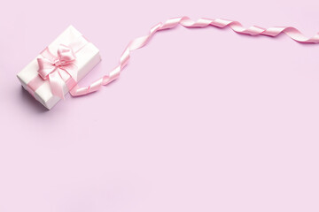 Gift box with beautiful bow and ribbon on pink background