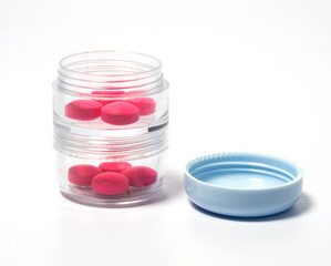 Pink pills in a double-walled pill box