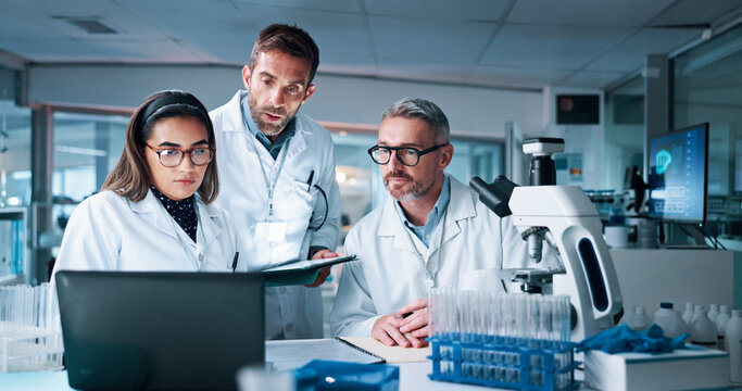 Laptop, medical and science with people in laboratory together for breakthrough or development. Computer, microscope and tablet with research team in clinical trial for DNA discovery or results