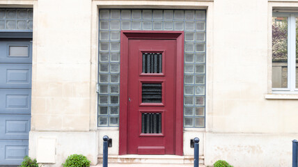 red French door wooden burgundy vintage traditional european entrance to a private house in city...