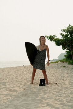 Young woman on beach after surfing