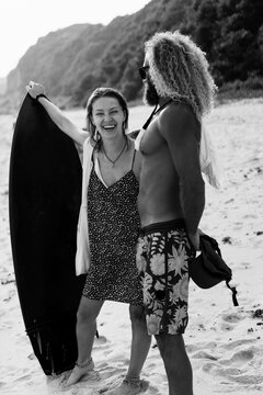 Happy friends with surfboards on the beach