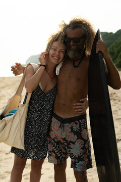 Couple on the beach with surfboards