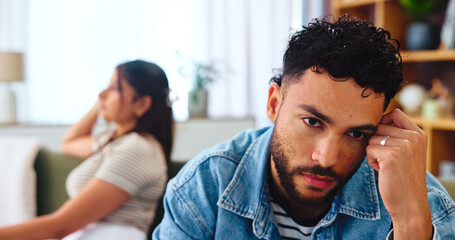 Argument, unhappy and couple in home, stress and newlyweds with financial disagreement or living room. Thinking, conflict and people with tension in relationship in lounge, frustrated and marriage