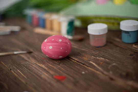 Table with paint and brush for painting easter eggs