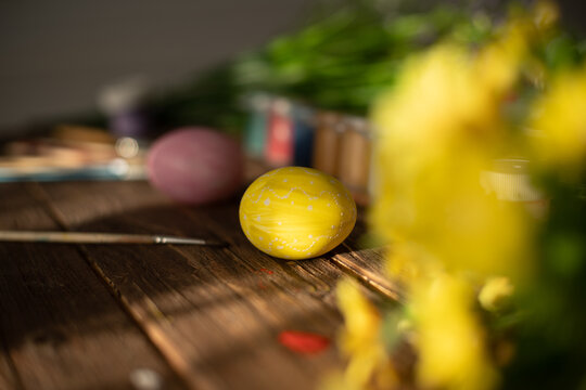 Table with paint and brush for painting easter eggs