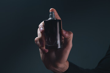 hand with bottle of perfume