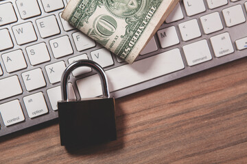 padlock and computer on wooden table background
