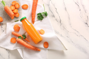 Bottle of fresh carrot juice with parsley on white background