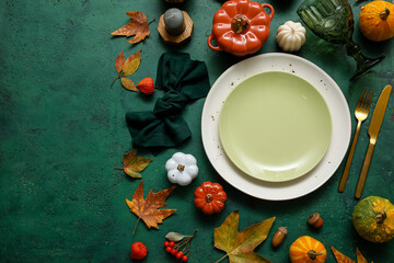 Beautiful table setting for Thanksgiving Day celebration on green background