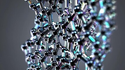 Graphene nanostructure rotating smoothly, revealing intricate molecular hexagonal lattice structure against minimalist gray backdrop, highlighting advanced scientific material design