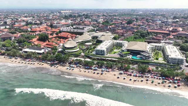 Aerial panoramic of hotel building and shopping centre on beachfront. Kuta Beach, Bali.