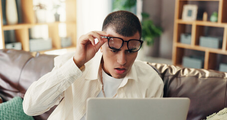 Man, glasses and shocked with laptop in home for internet glitch, 404 error and online application fail. Surprised, person and technology with connection problem, information loss and website crisis