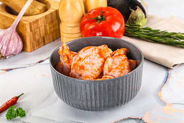 Raw marinated uncooked chicken wings