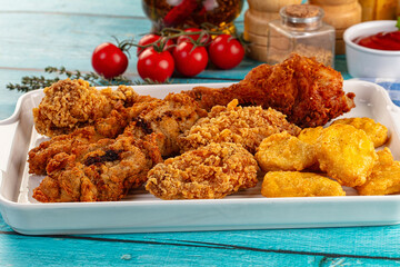 Golden crispy fried chicken mix - wings, drumsticks, nuggets and strips