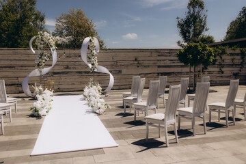 Charming Outdoor Wedding Setup with Elegant White Decor and Floral Arrangements