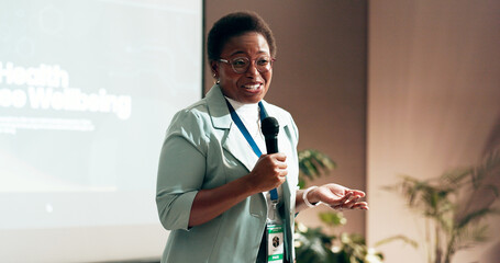Business woman, development and presentation for speaker in conference room for wellness training. Education, forum speech and microphone with corporate coach on stage for public relations or seminar