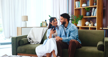 Couple, phone and gossip on sofa with hug, social media and funny story in home. Woman, man and...