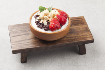  Patbingsu is a food made by crushing ice into small pieces and adding boiled red beans or sugar.