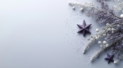 Flat lay of a light blue background with a bunch of purple and white flowers on the right side. on the left side, there are two purple star-shaped objects that appear to be floating in the air.