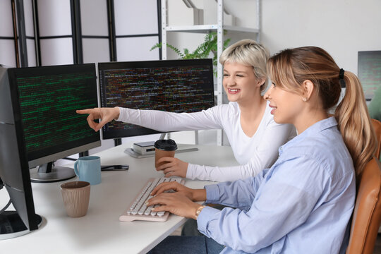 Female programmers working at table in office