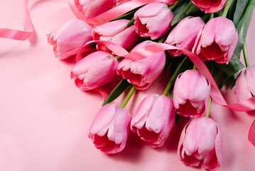 Obraz premium Mothers day, Valentines Day, Birthday celebration concept. Greeting card. Beautiful Bouquet of pink delicate tulips. Copy space for text, top view. Spring background. March 8, International Womens Day