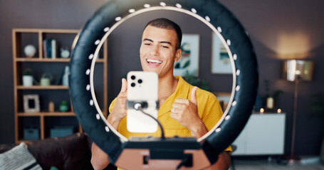 Man, influencer and thumbs up with ring light in home for live streaming, video or post on social...