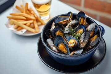 Belgian mussels with fries and beer outdoors