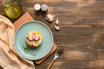 Plate of salad with crab sticks and corn on wooden background © Pixel-Shot