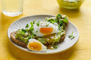 bruschetta with guacamole sauce and poached egg